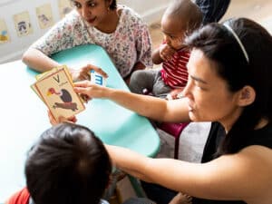 early childhood educators working with young children in classroom 