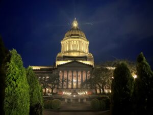 The south-facing entrance of the WA State Legislative Building at night during the seventh week of the 2026 WA State Legislative Session.