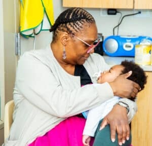 Woman holding child.