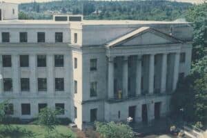 The exterior of the Washington State Public Health Building in 1988. Two people are working on the facade of the building.