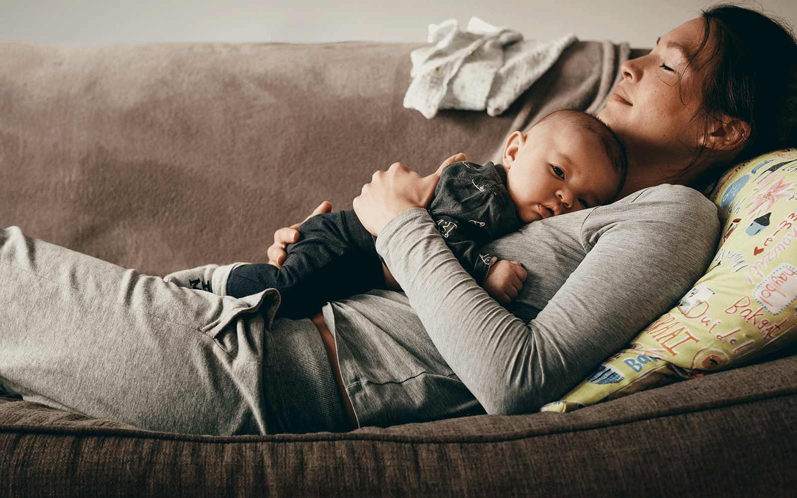 Mother and child resting on couch
